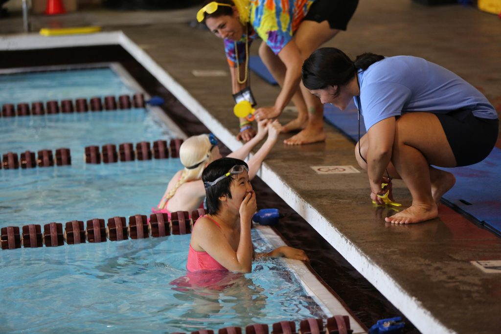 Camper super excited they finished a race. Coach telling them their time.