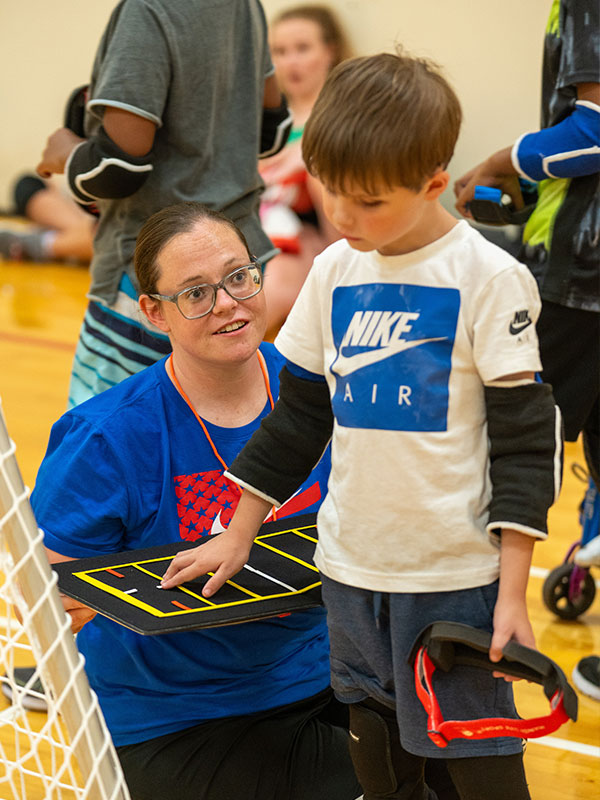 a young boy is presented with a tactile map to learn how to play a gym game