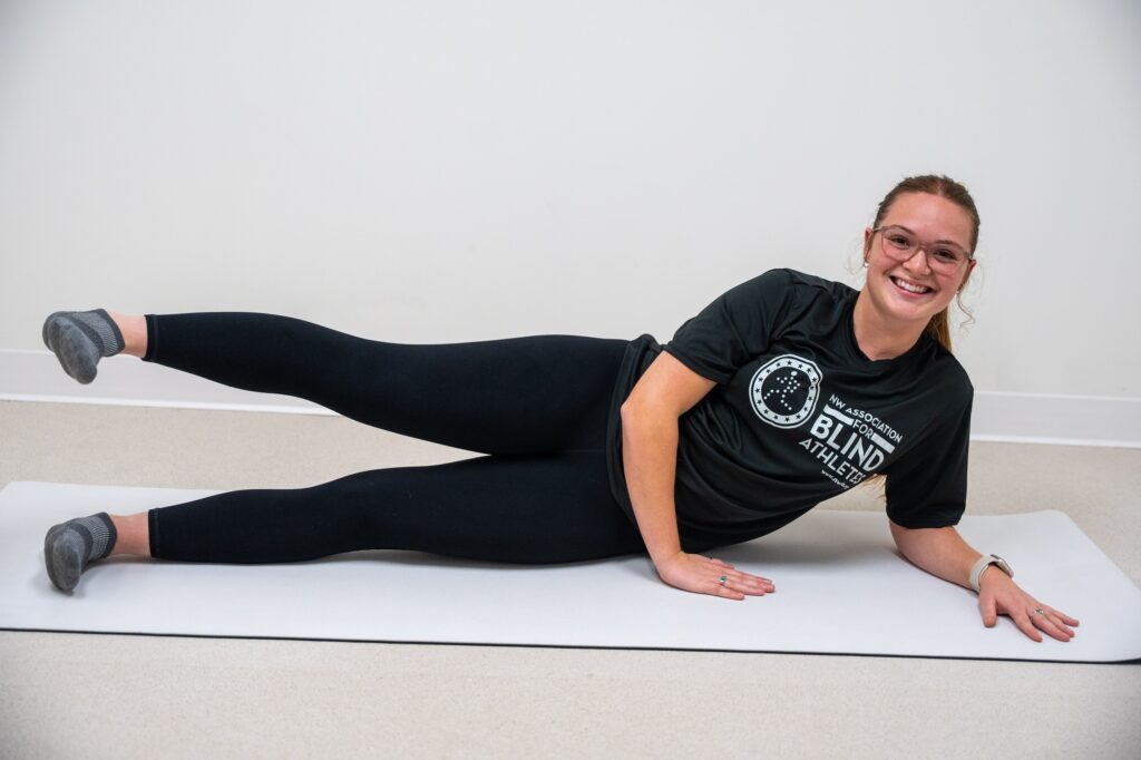 Anneliese demonstrating side lying leg abductions